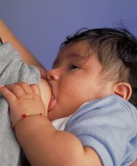 A mother nursing an infant.