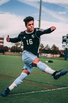 Kicking a soccer ball.