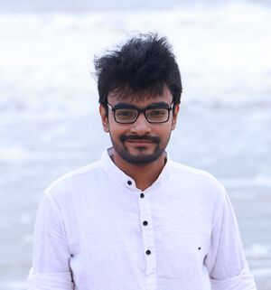 This is the profile picture of Krishnakali Das. He wears a spectacle and white shirt in the image.