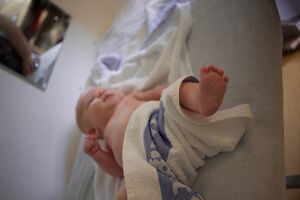 Nate at the Chelsea & Westminster Hospital Ponseti clinic - first fitting of boots and bars